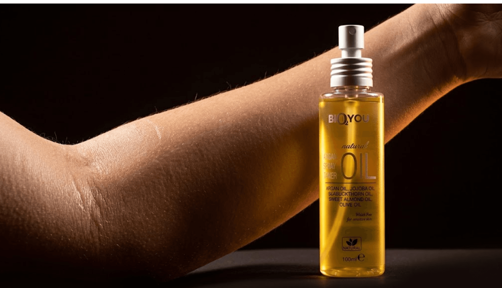 Bottle of oil next to arm